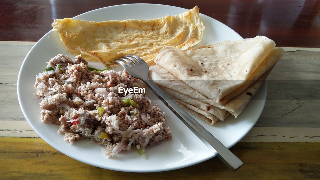 High angle view of mashuni and roshi served in plate on table