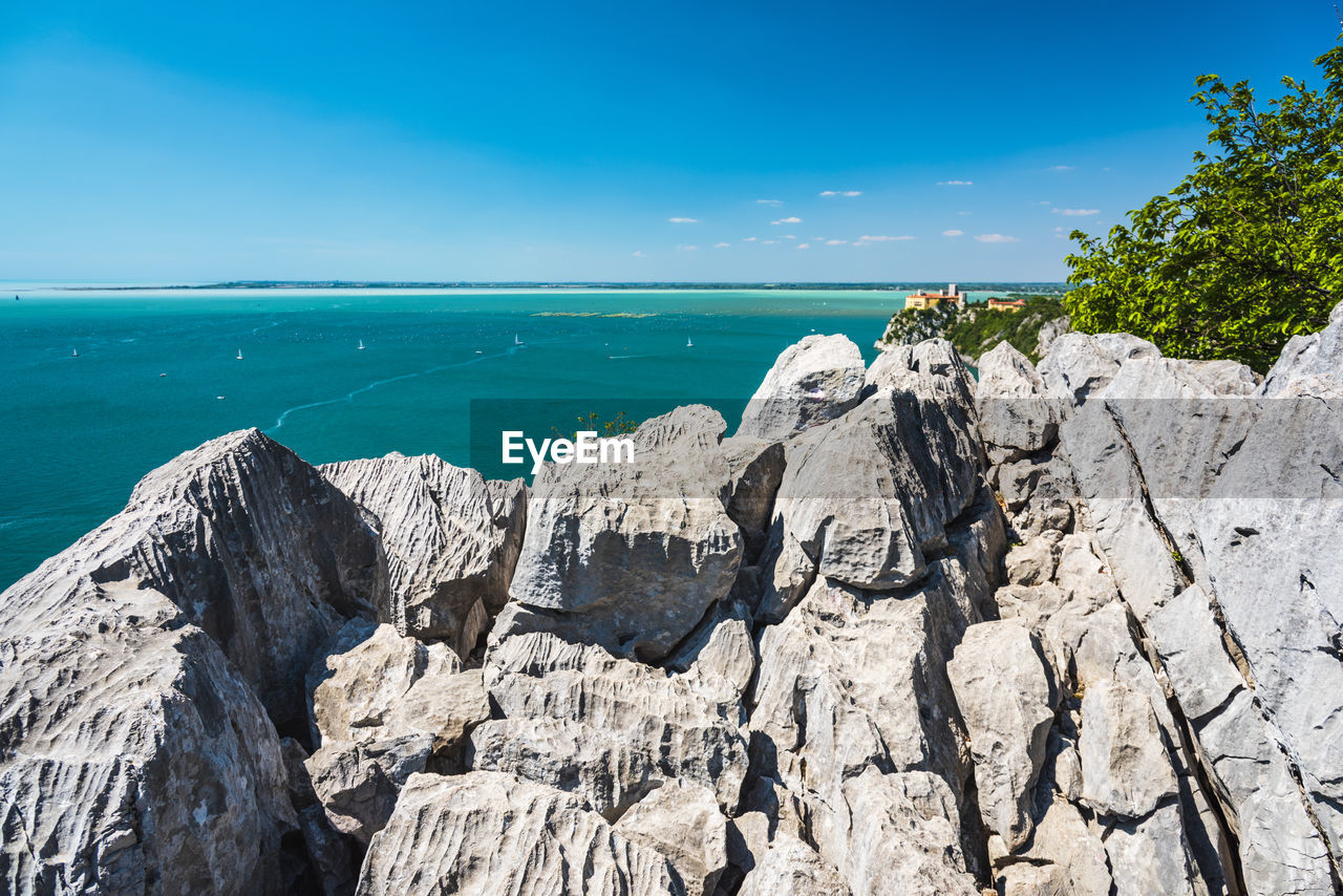 Gulf of trieste. high cliffs between boats, karst rocks and ancient castles. duino. italy