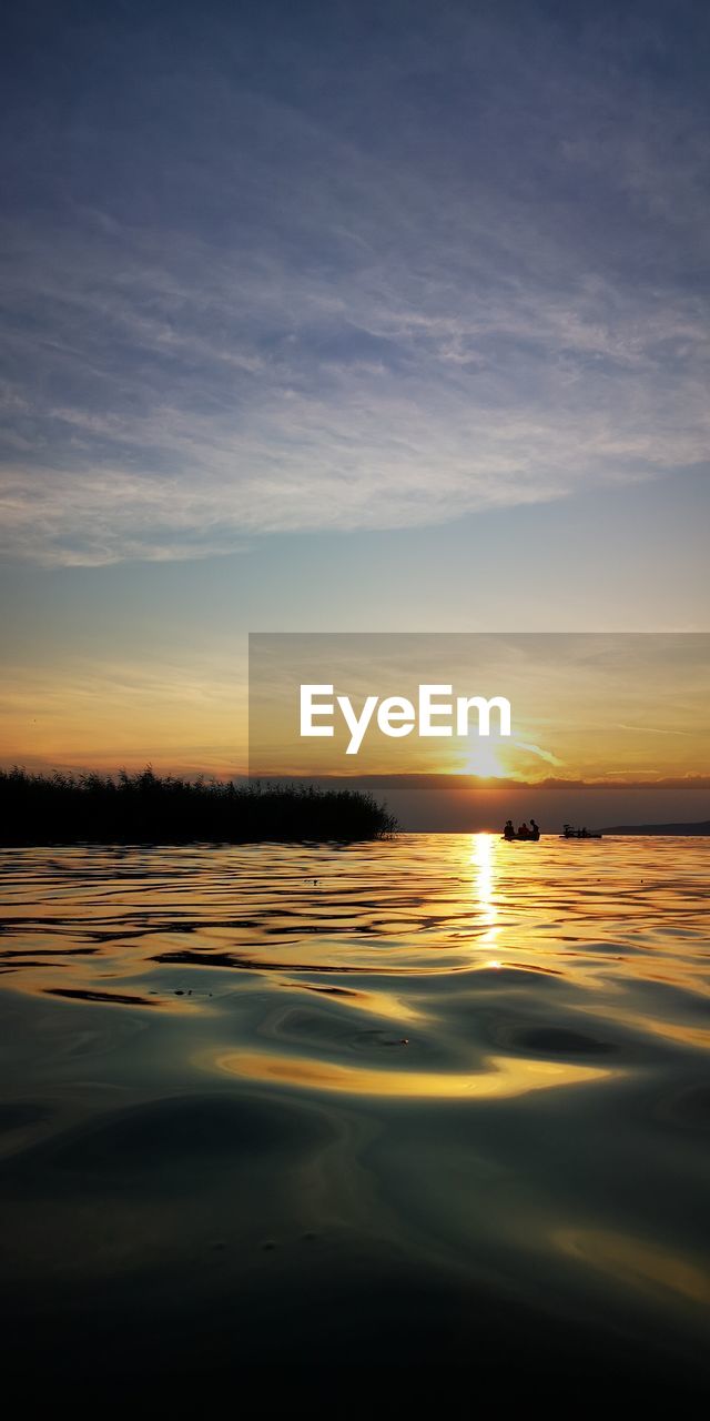 Scenic view of lake against sky during sunset