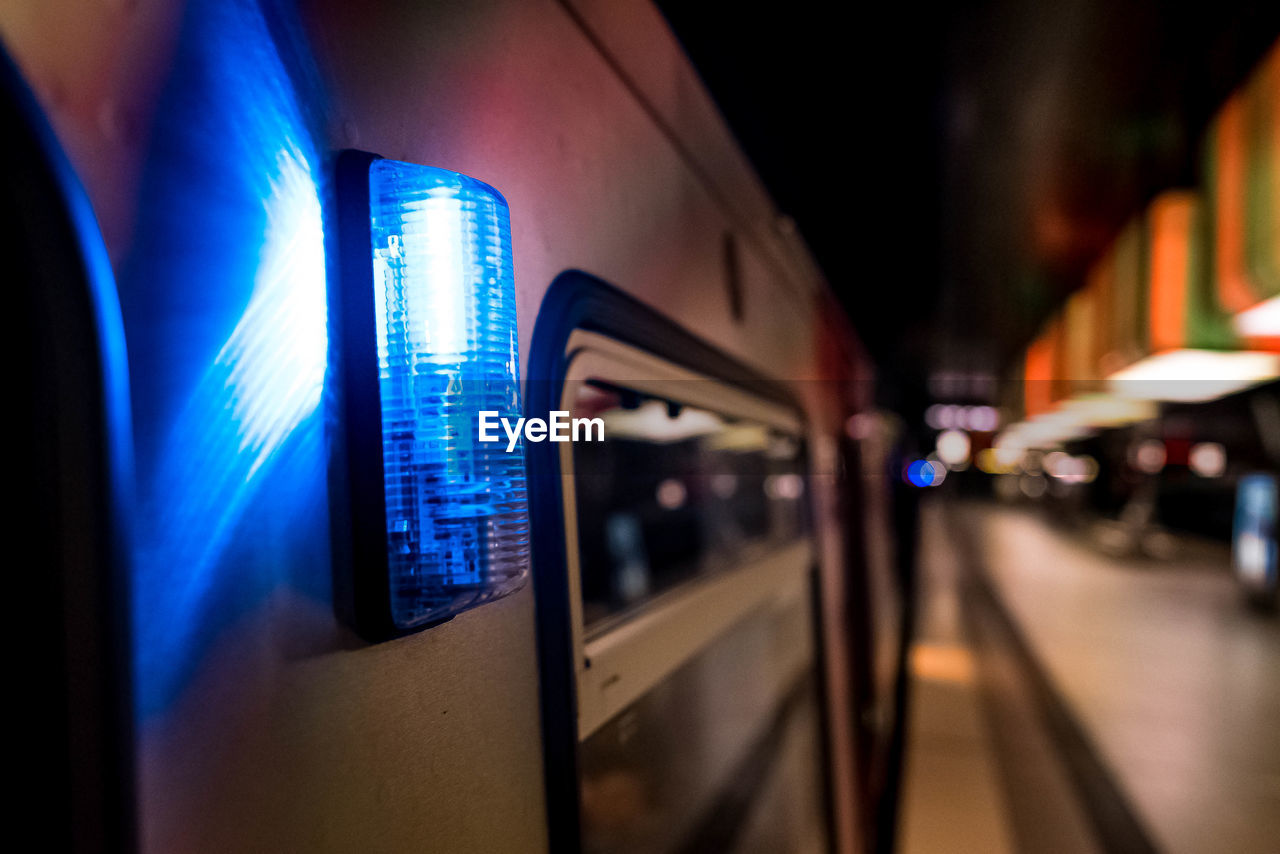 TRAIN ON ILLUMINATED RAILROAD STATION PLATFORM