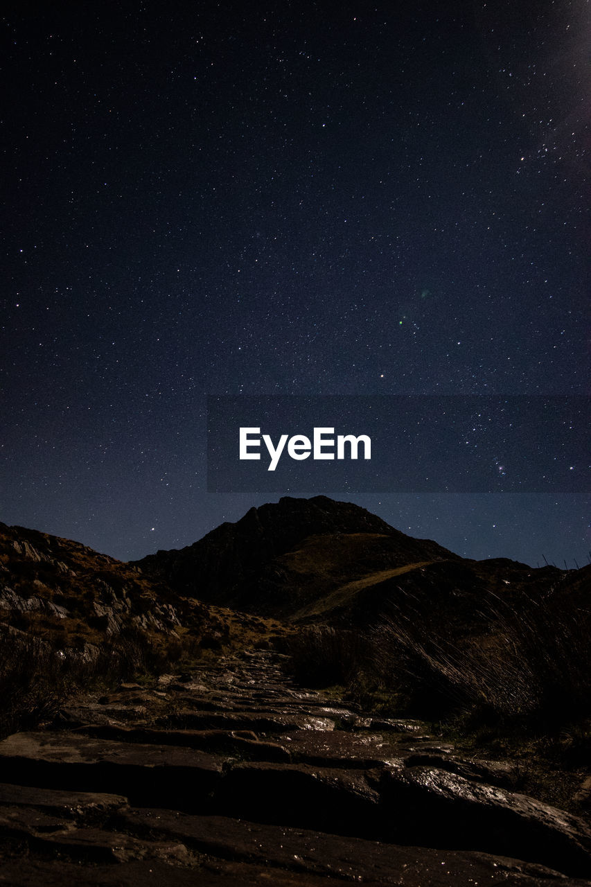 Scenic view of landscape against sky at night