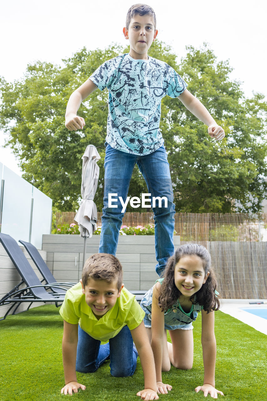 Three friends making an human tower