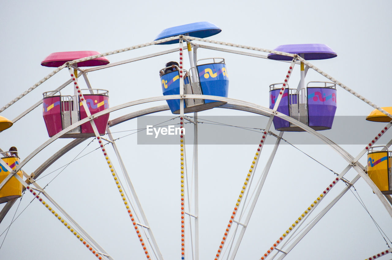 LOW ANGLE VIEW OF ROLLERCOASTER AGAINST SKY