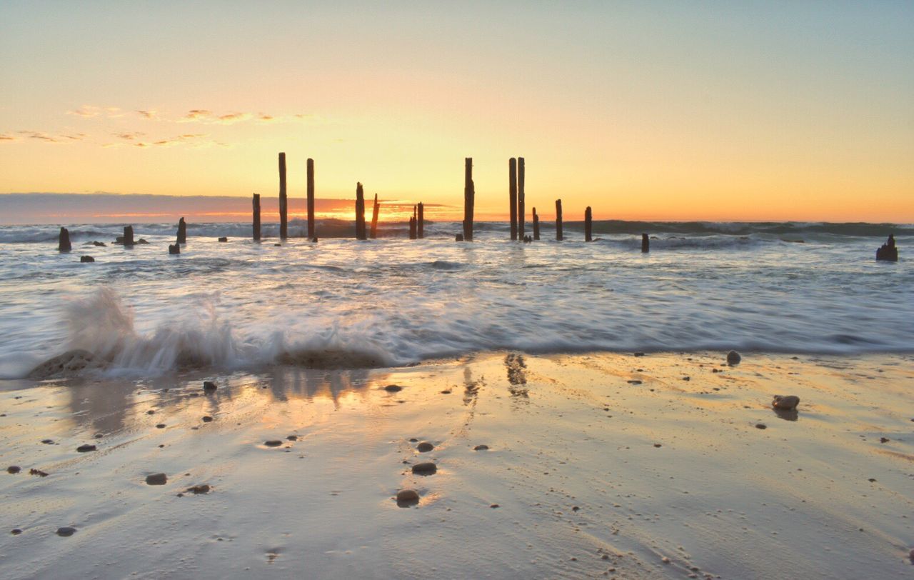 Scenic view of beach against sky during sunset