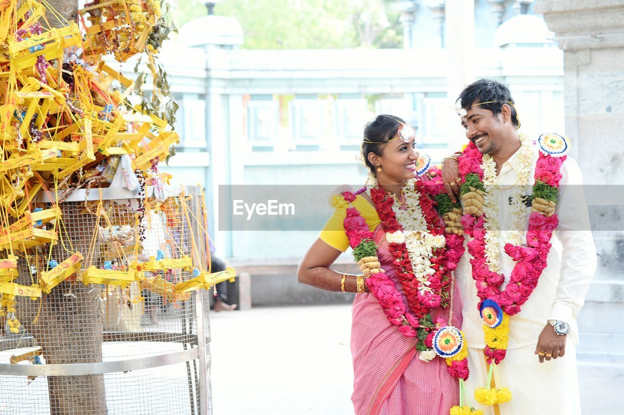 Happy couple standing at temple