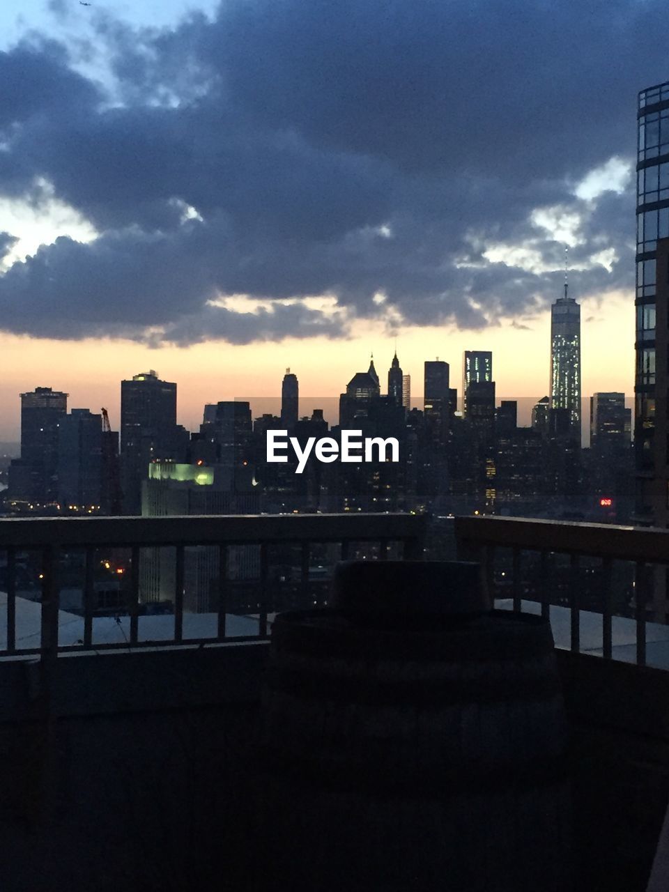 View of skyscrapers lit up at dusk in city