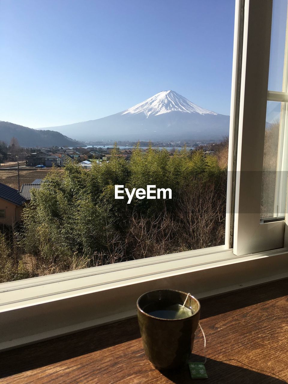 Tea by window with mountain in background
