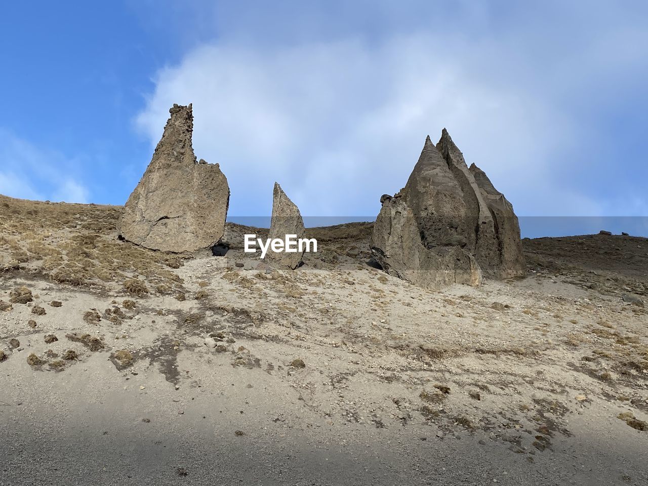 LOW ANGLE VIEW OF ROCK FORMATION AGAINST SKY