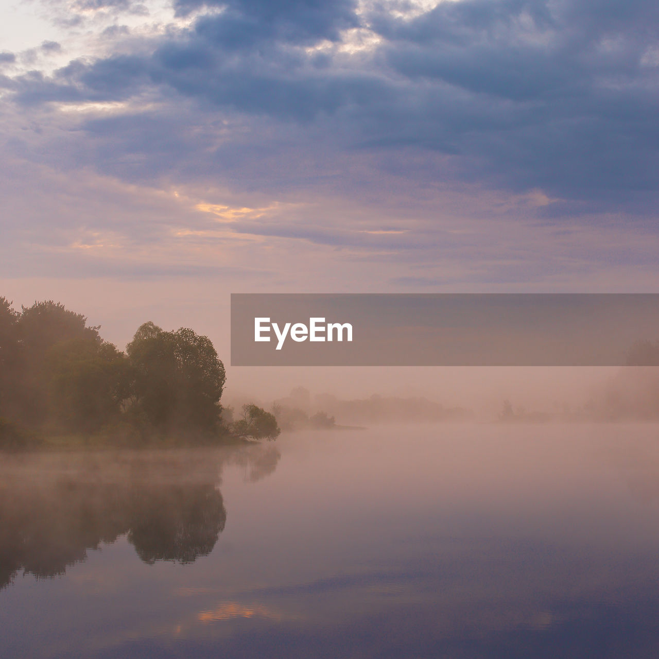 SCENIC VIEW OF LAKE BY TREES AGAINST SKY