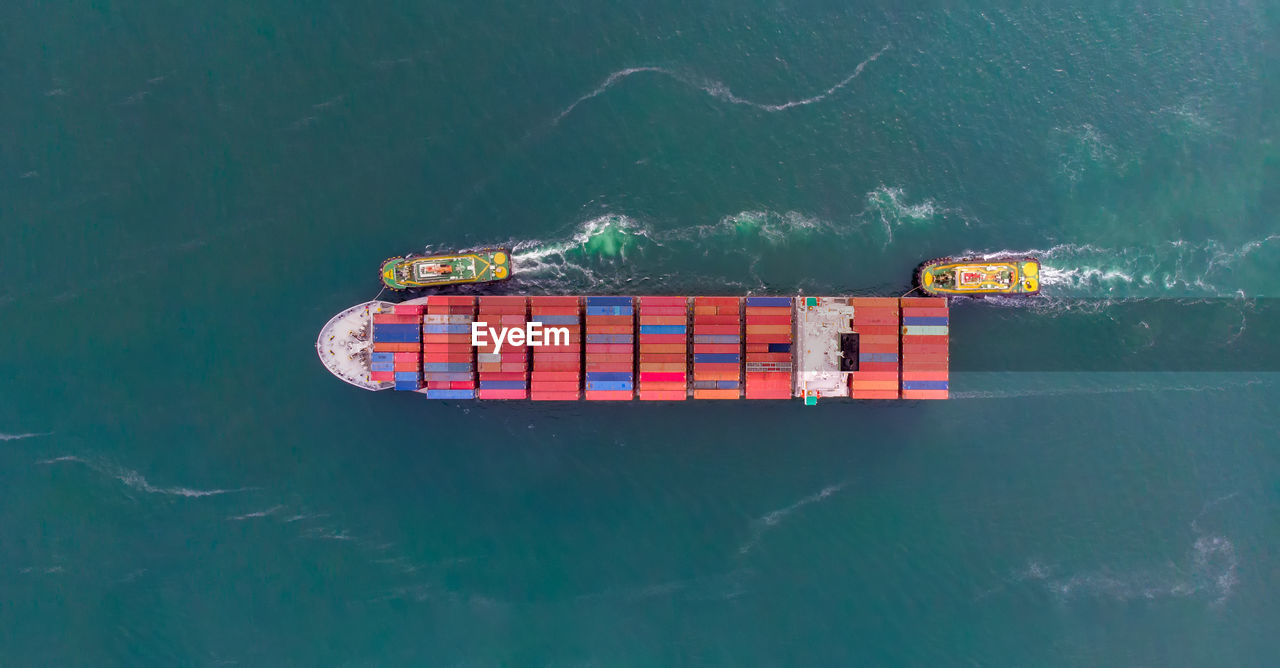 Aerial view of container ship sailing in sea