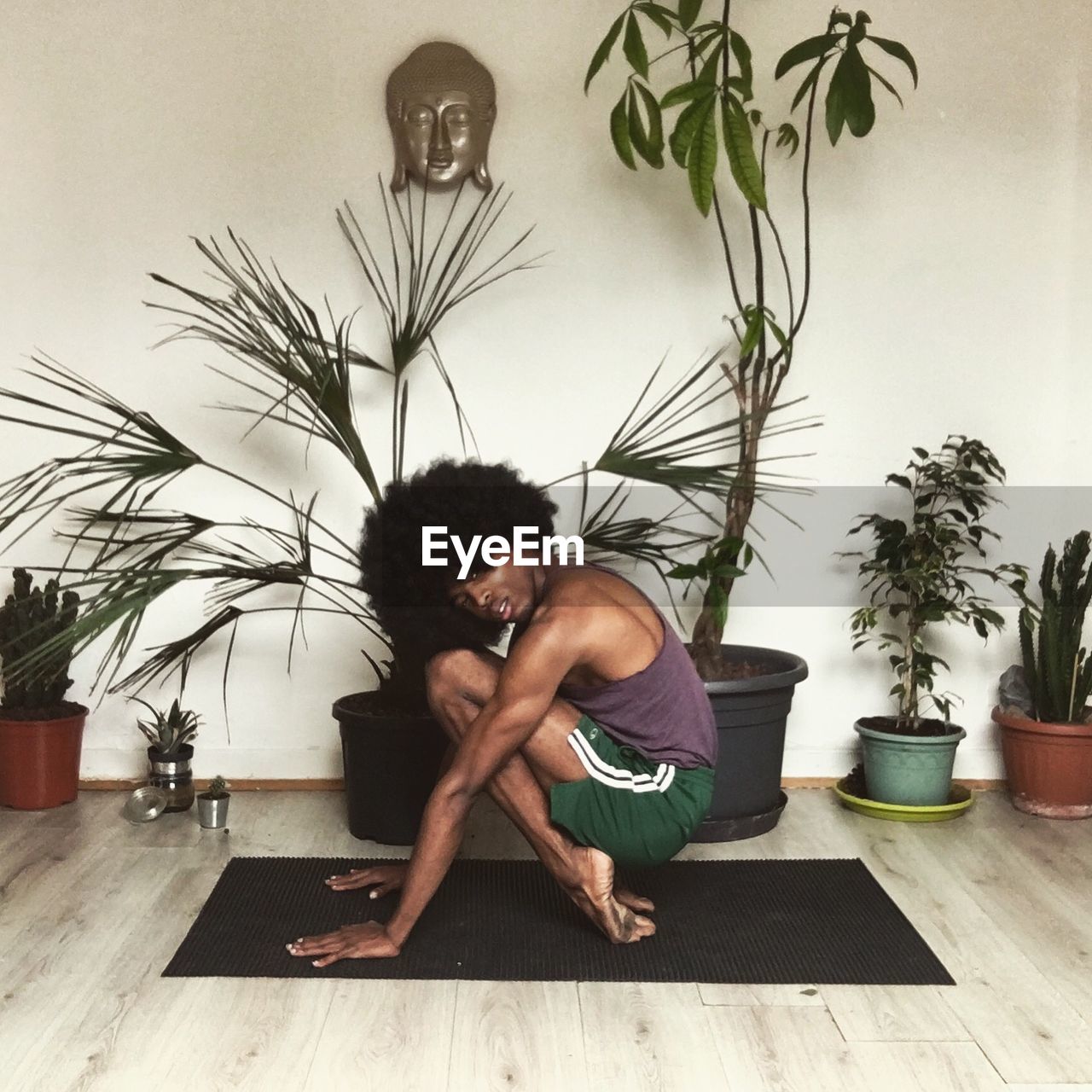 Man doing yoga at home