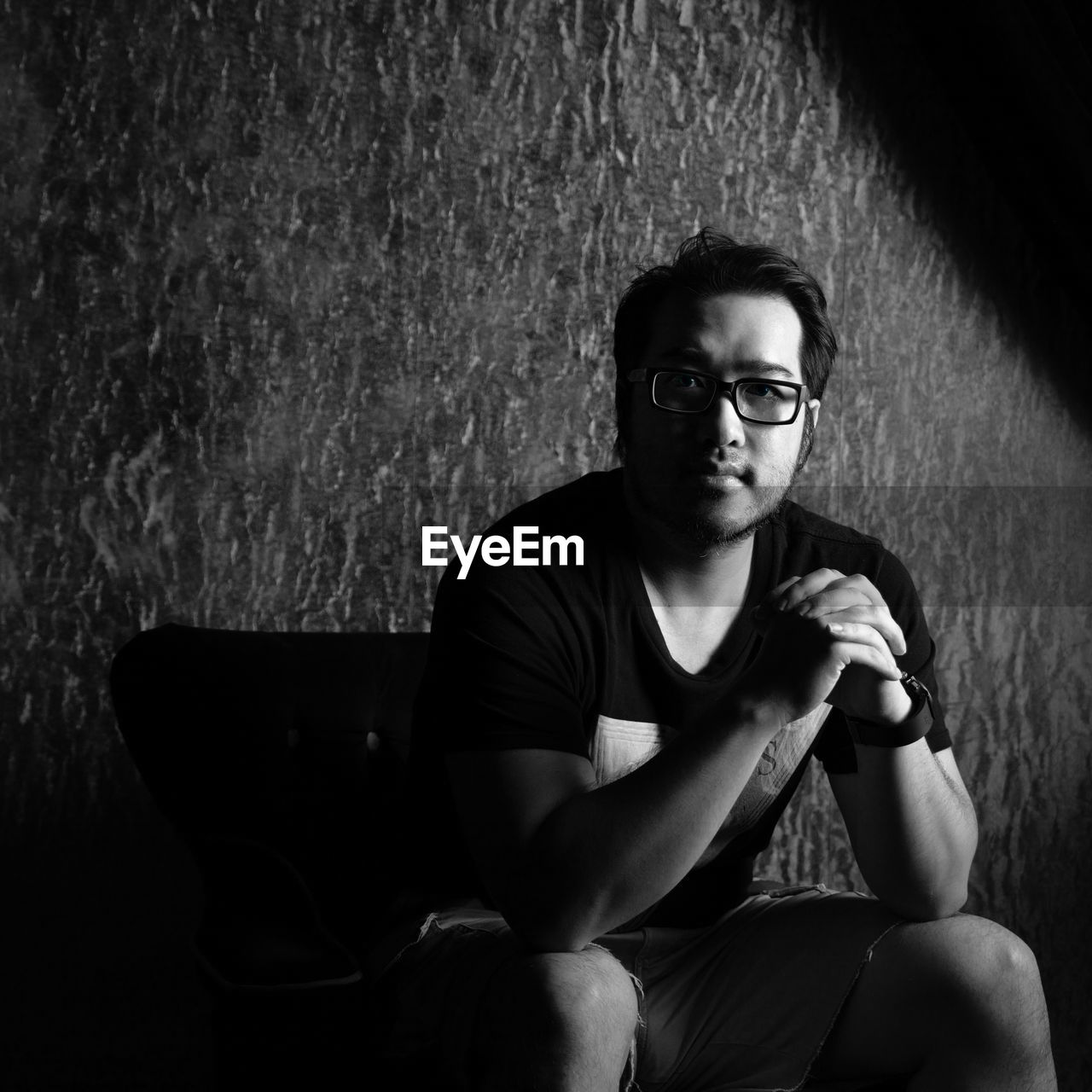 Portrait of mid adult man sitting on chair at home