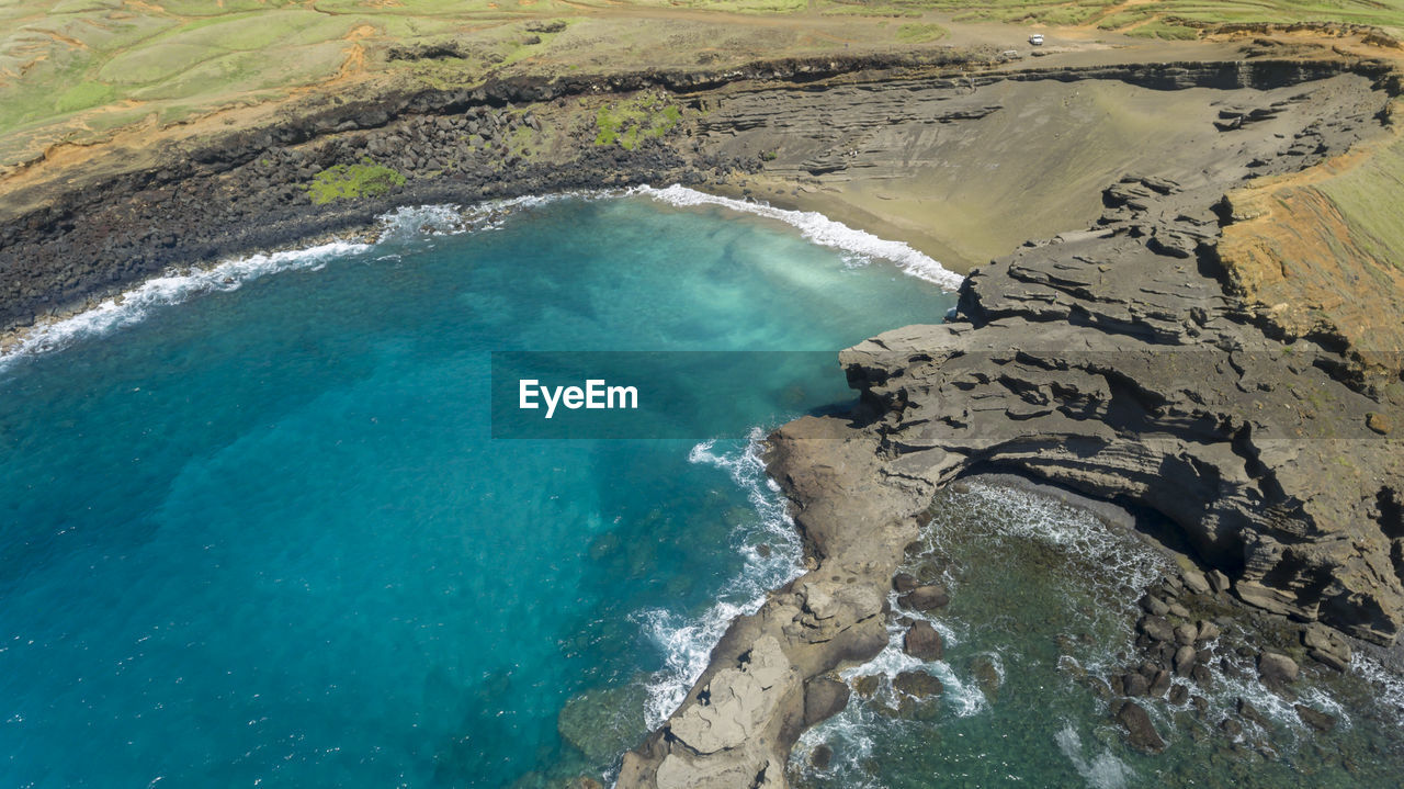 HIGH ANGLE VIEW OF SURF ON BEACH