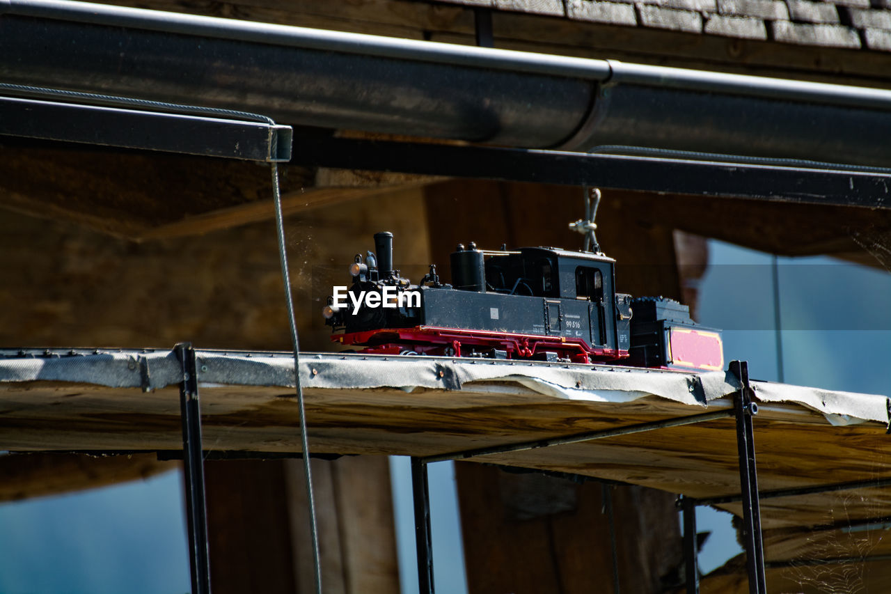 LOW ANGLE VIEW OF MACHINE HANGING ON CEILING