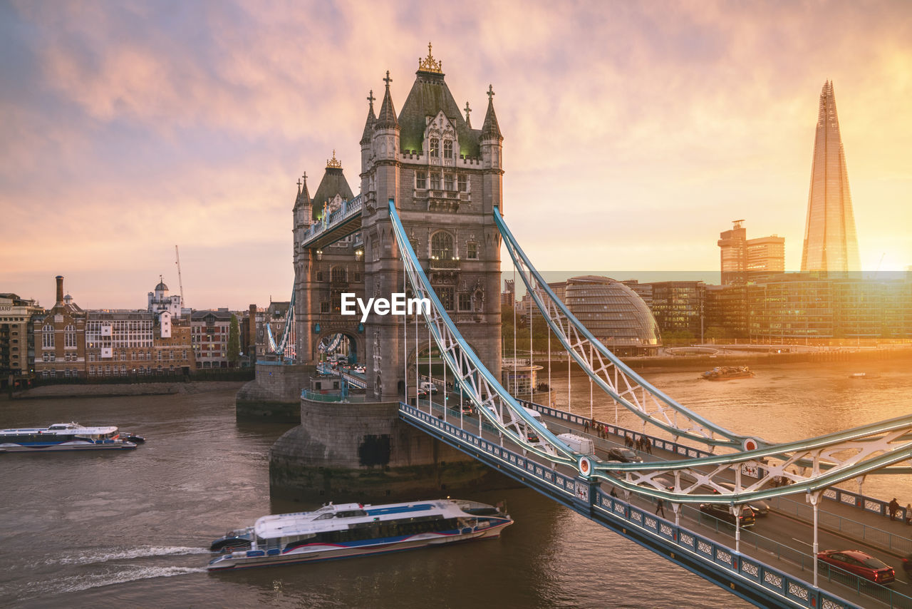 Tower bridge over thames river during sunset in city