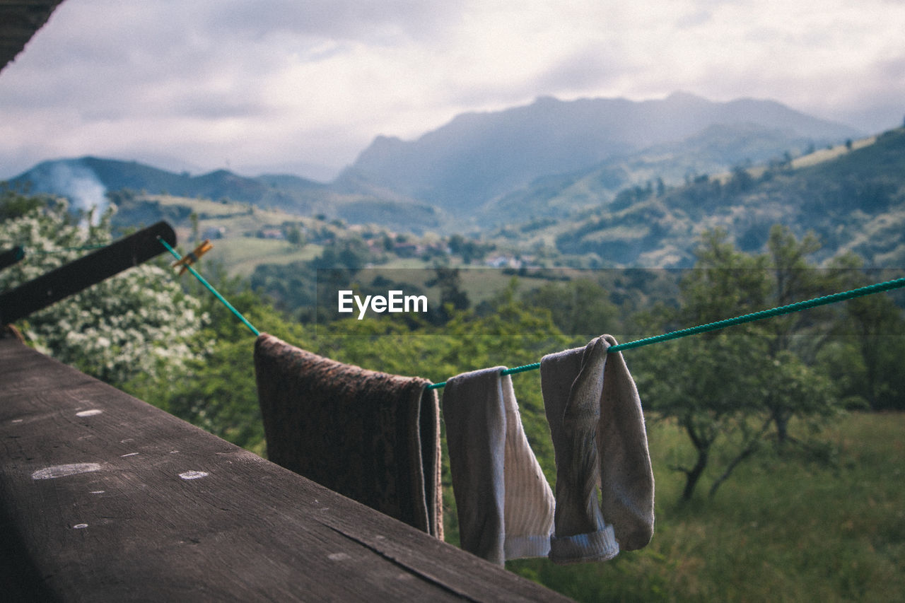 Clothesline hanging in balcony against mountains