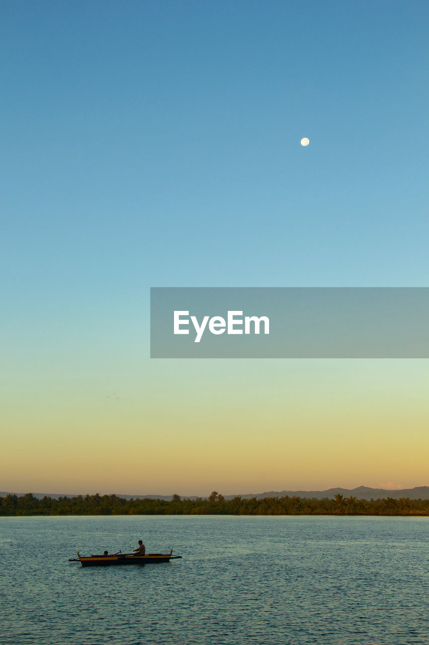 Scenic view of sea against clear sky during sunset