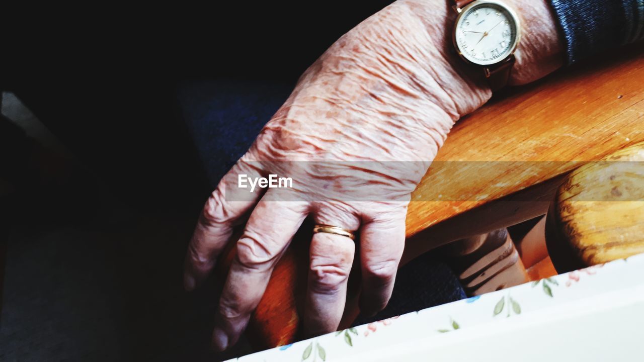 Close-up of wrinkled human hand at home