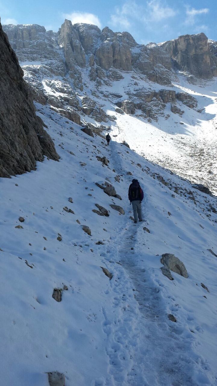 Man hiking on snowcapped mountain