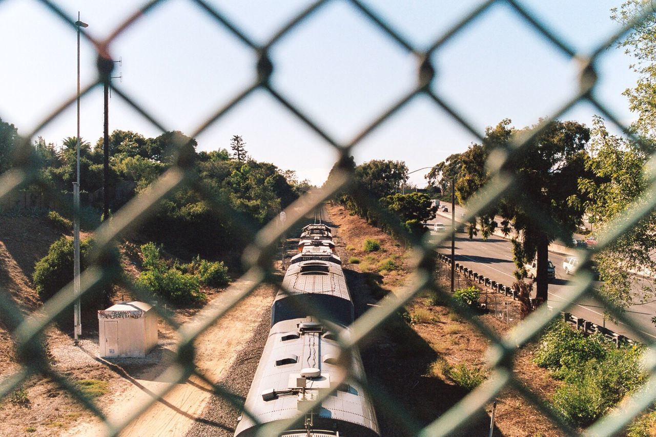 High angle view of train seen through fence