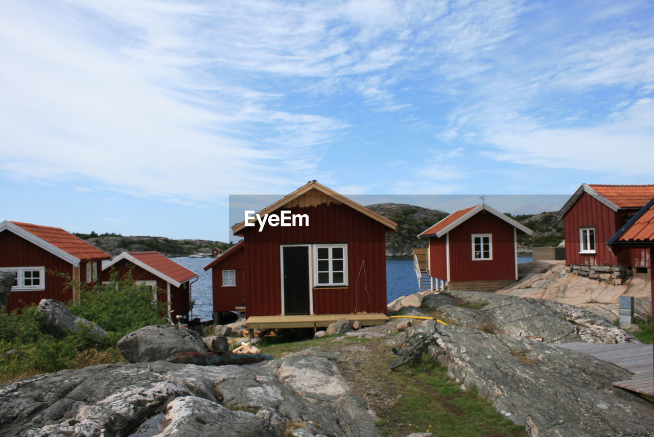 Houses against cloudy sky