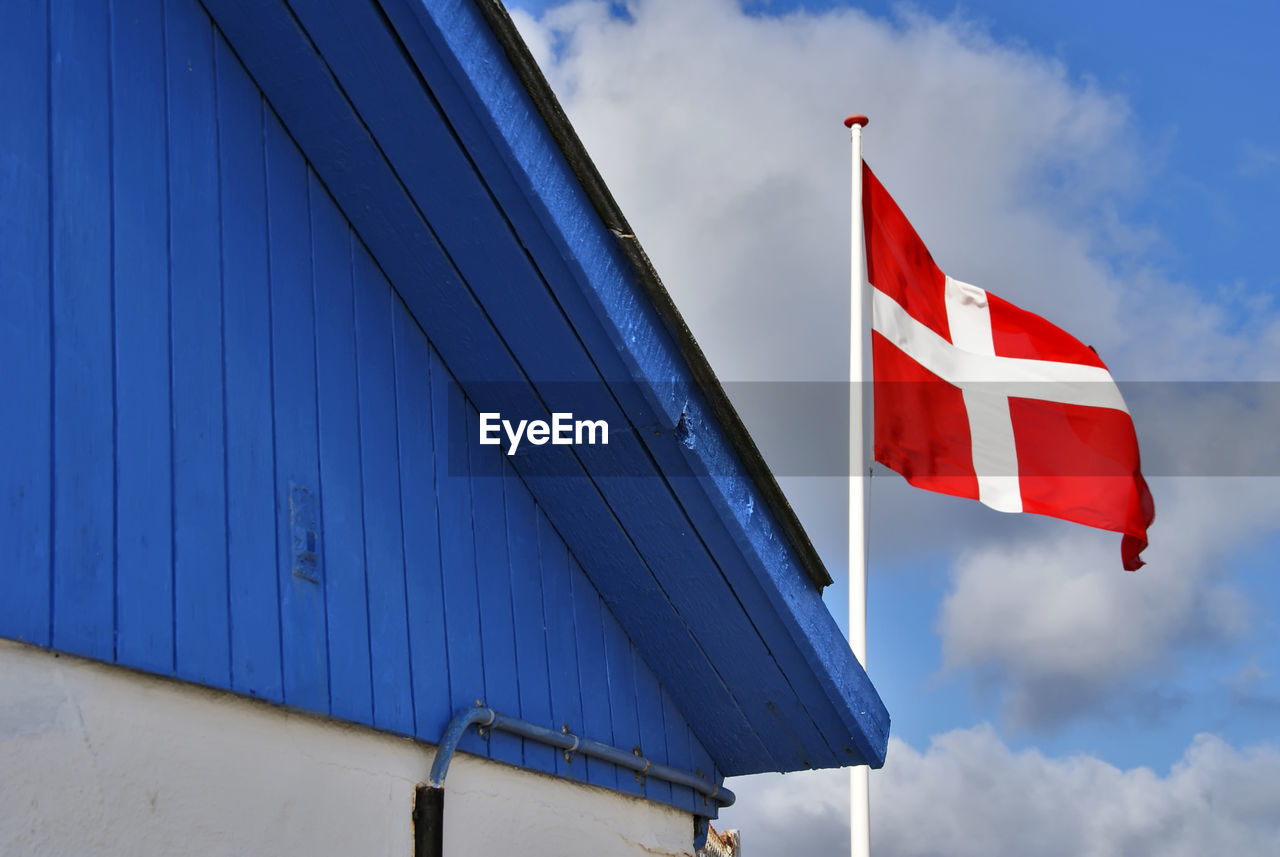 Low angle view of denmark flag against sky