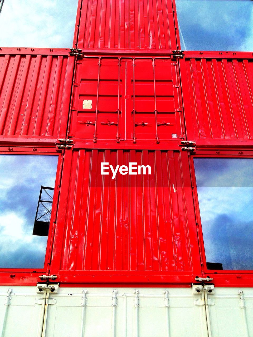 Red cross shape on container with reflection