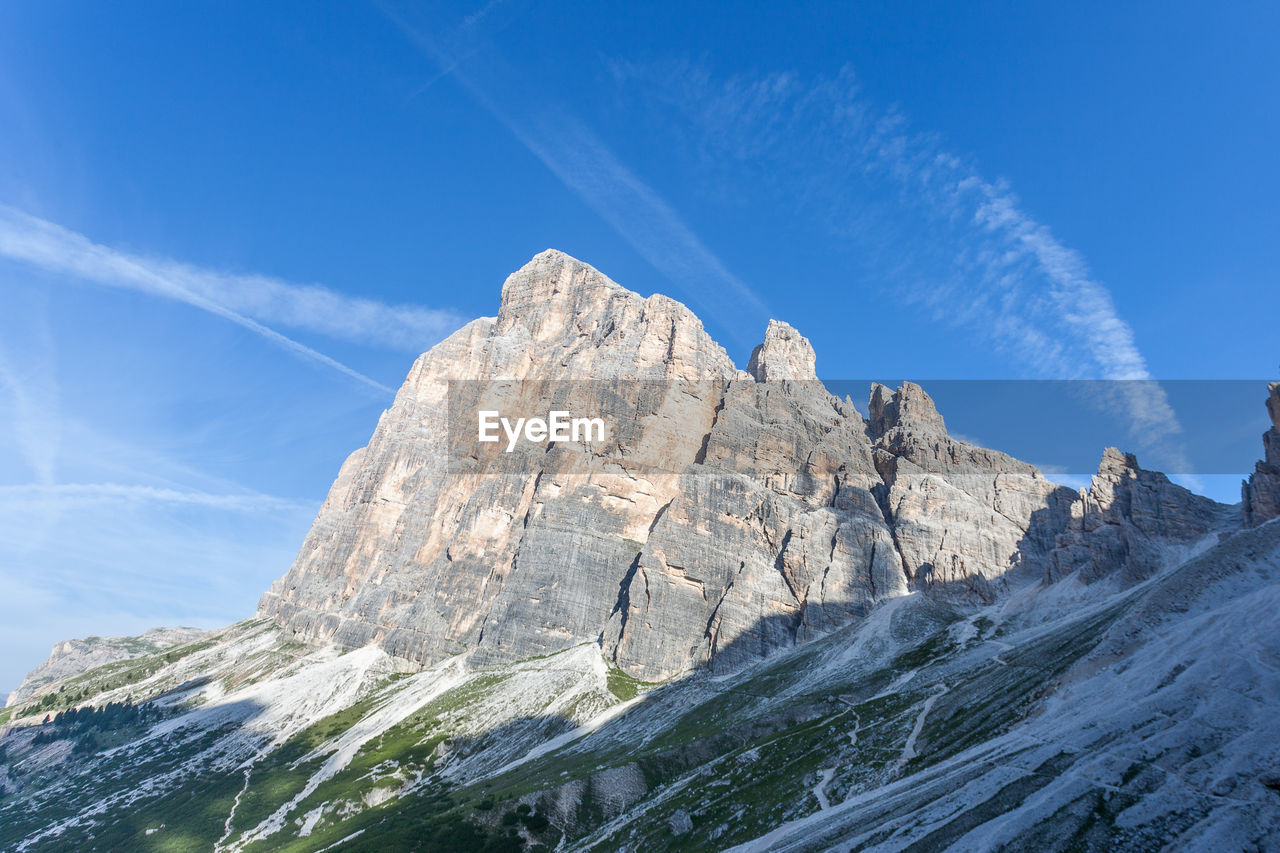 Scenic view of rocky mountains against blue sky