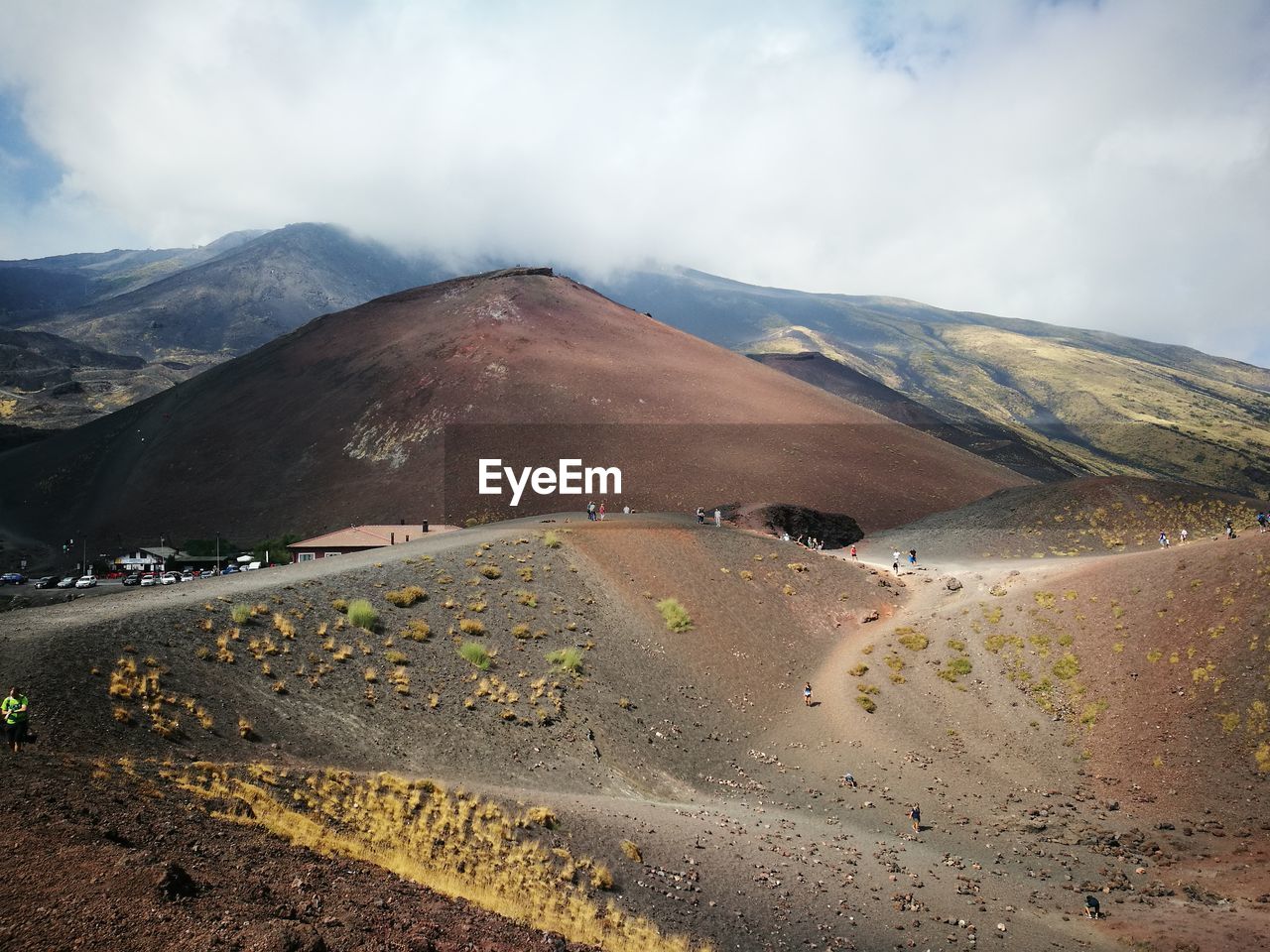 Scenic view of road by mountains against sky