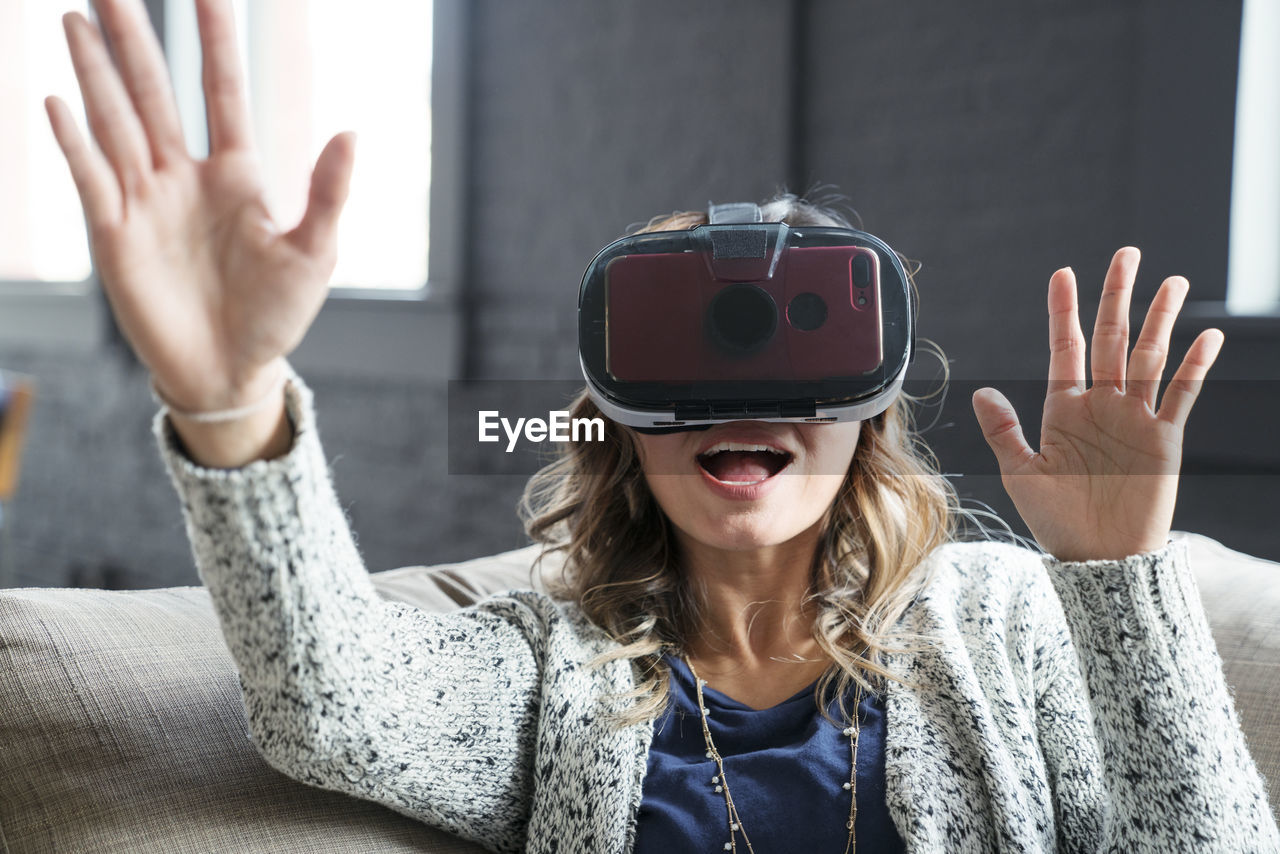 Businesswoman wearing virtual reality simulator in office