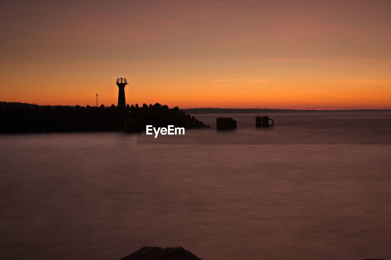 Scenic view of lake against sky during sunset