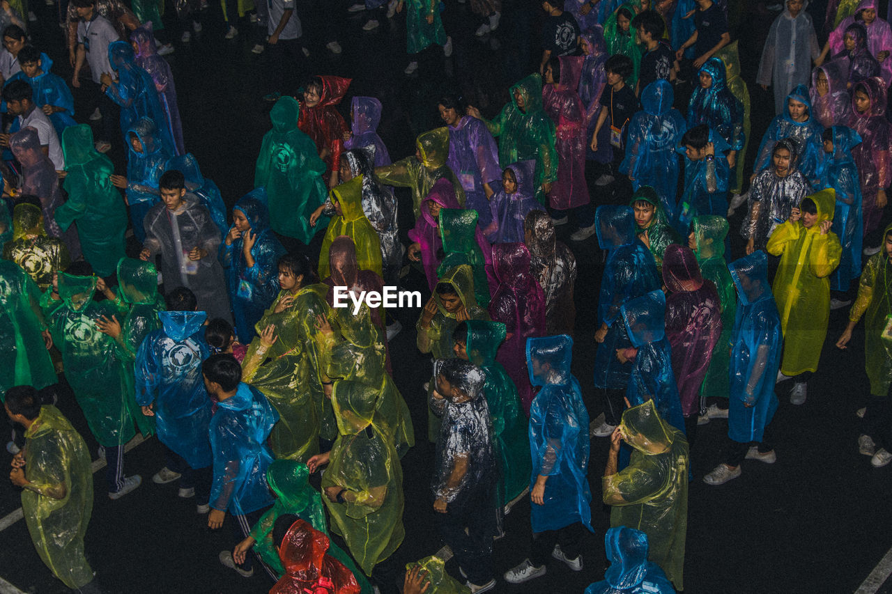 High angle view of people wearing raincoats while standing on road during rainy season