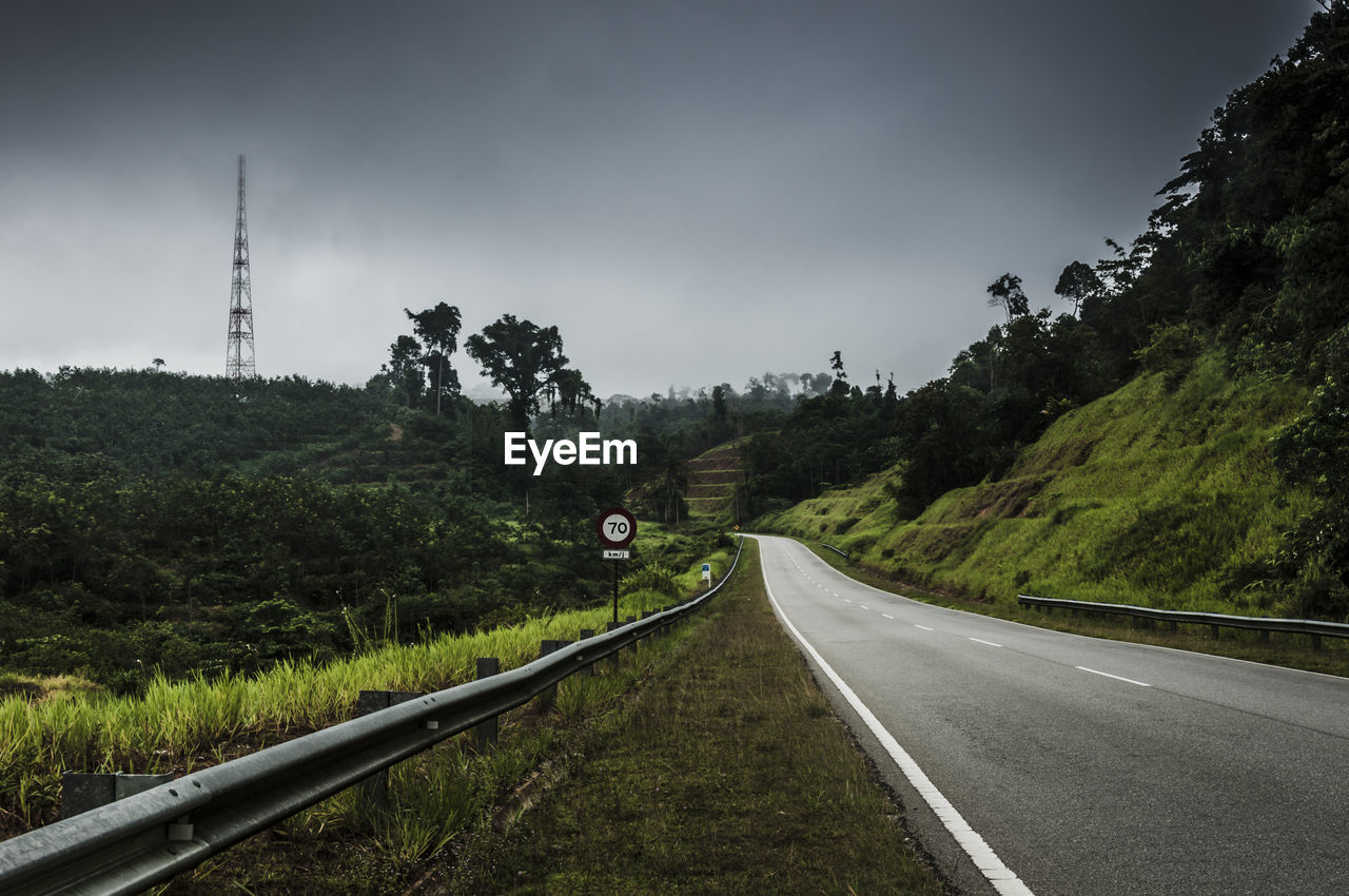 Empty road by mountain against sky