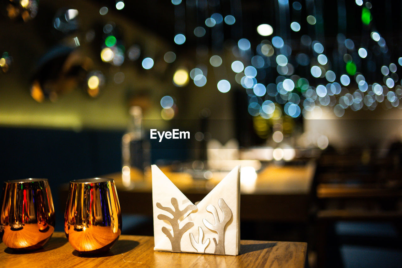 Close-up of glasses with tissue papers on table