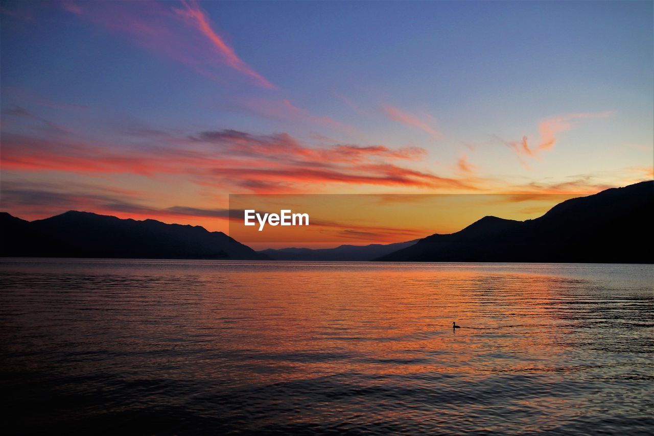 SCENIC VIEW OF SEA AGAINST ORANGE SKY