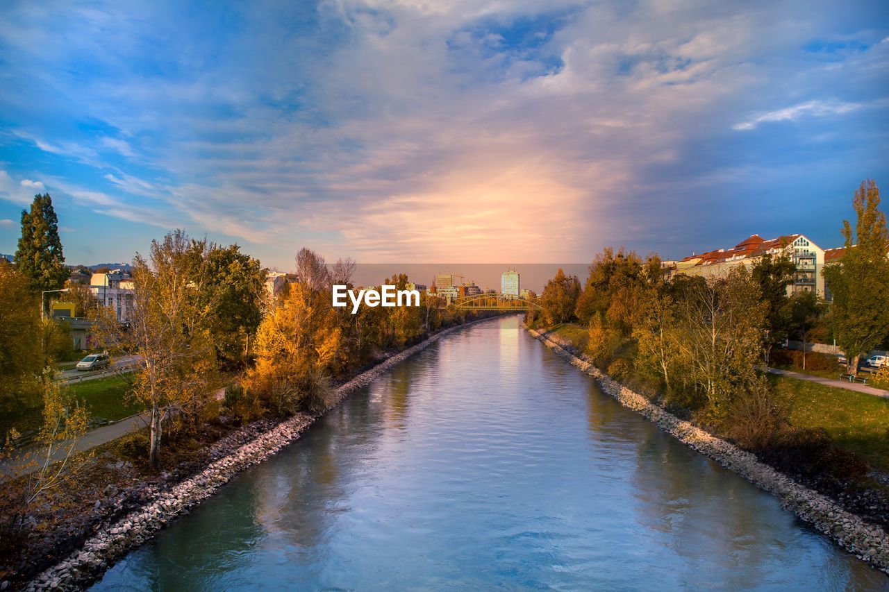 River amidst buildings against sky