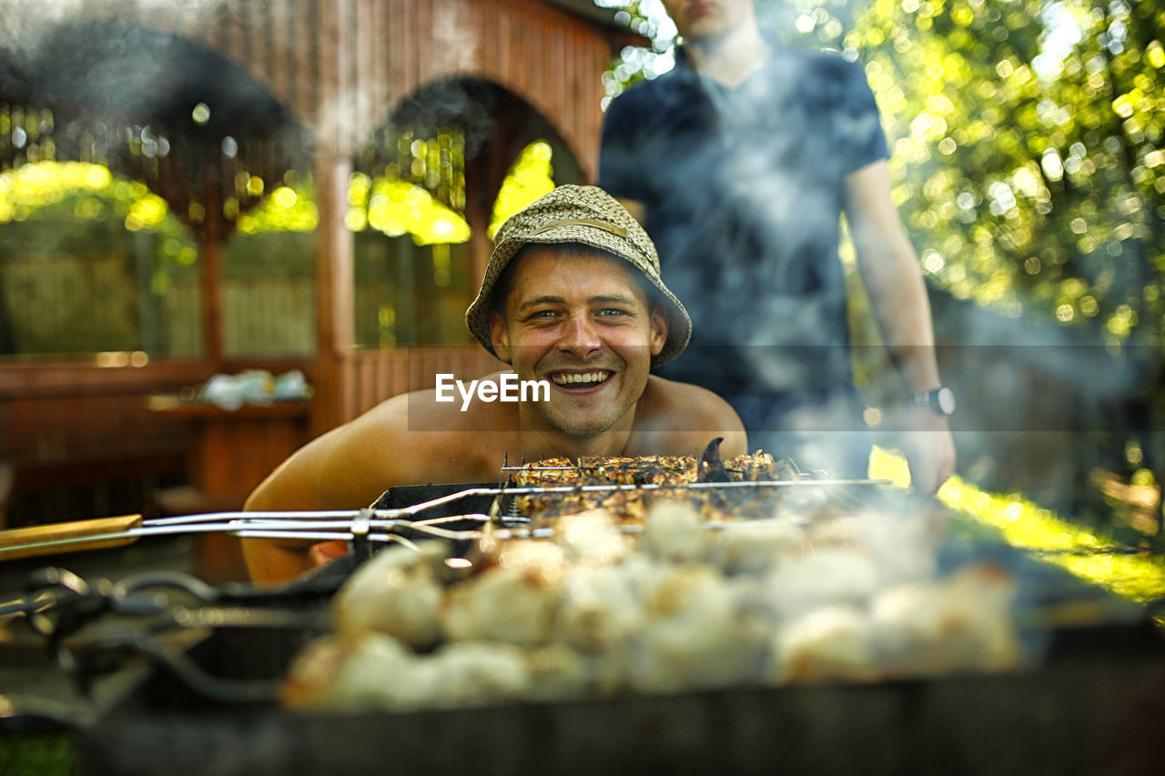 PORTRAIT OF SMILING MAN OUTDOORS