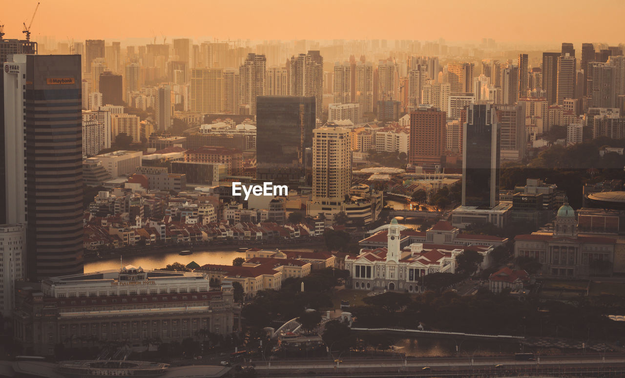 High angle view of buildings in city against sky during sunset