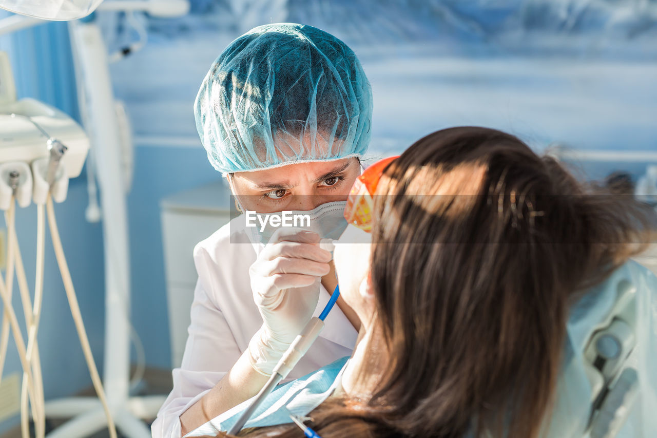 Dentist examining teeth of patient