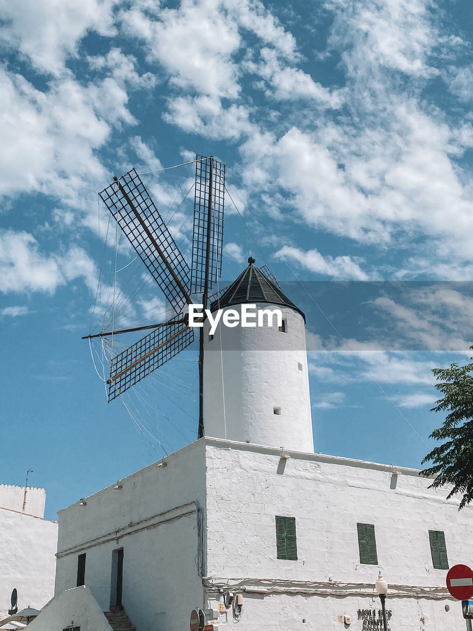 Low angle view of traditional windmill against sky