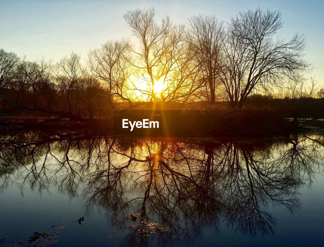 SCENIC VIEW OF LAKE AT SUNSET