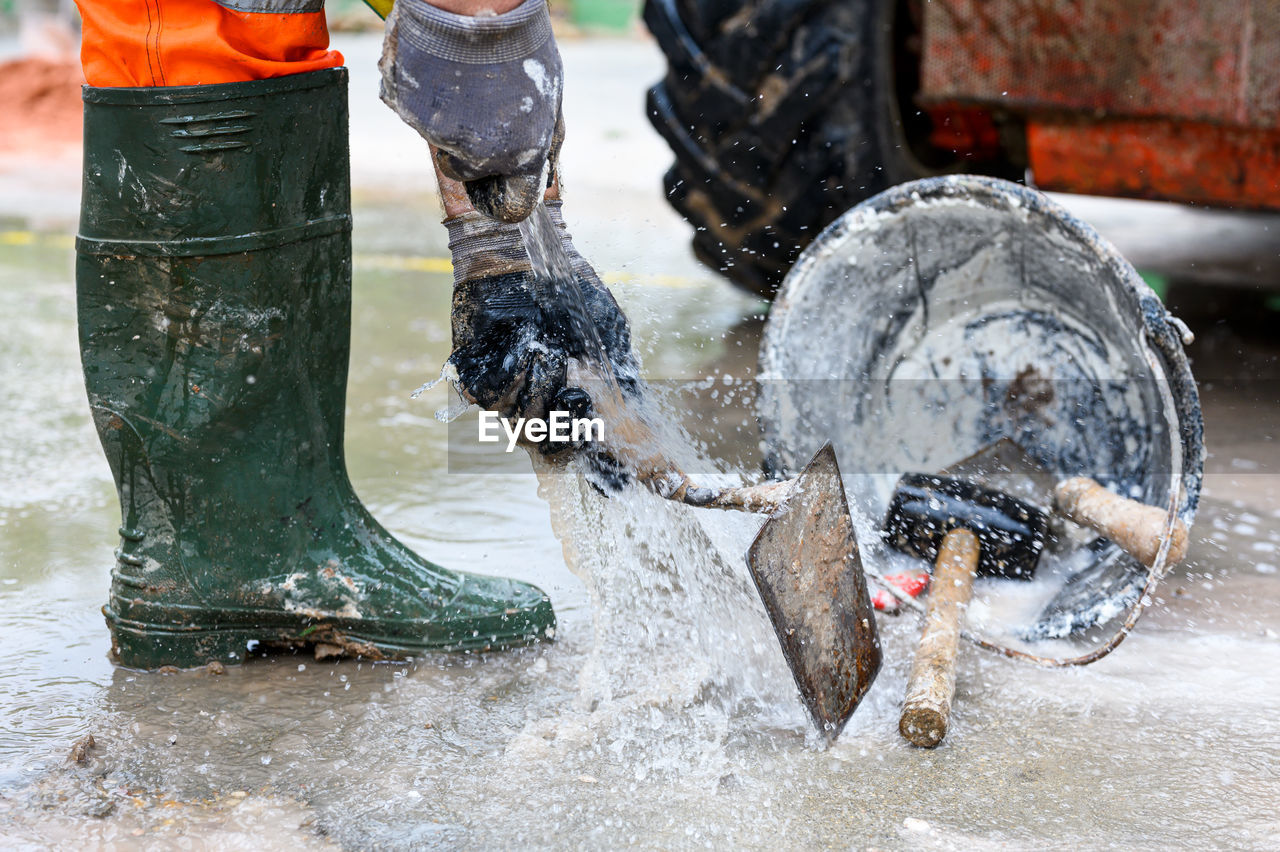 LOW SECTION OF PEOPLE SPLASHING WATER IN TANK