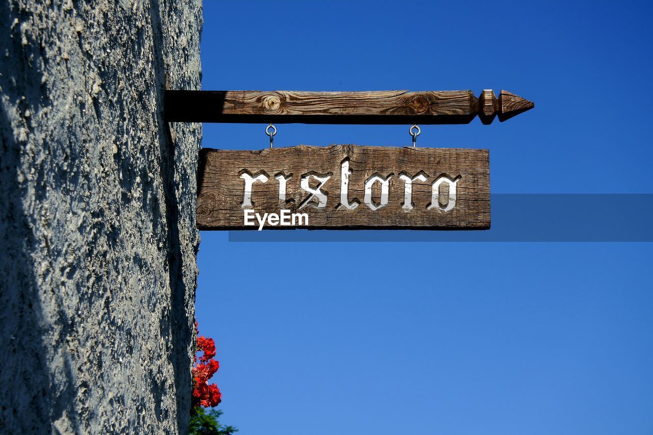 LOW ANGLE VIEW OF INFORMATION SIGN AGAINST SKY