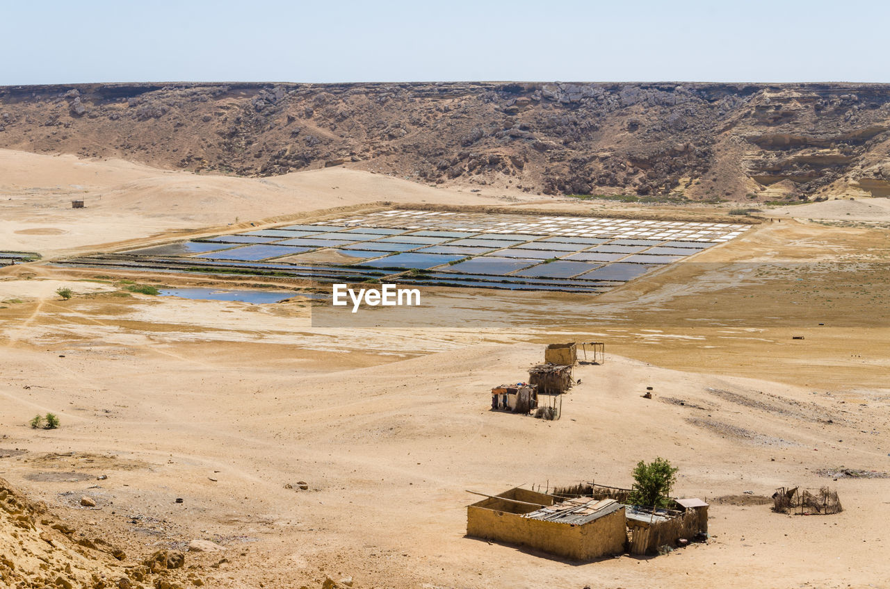 Scenic view of salt mining in desert against clear sky, mucuio, angola