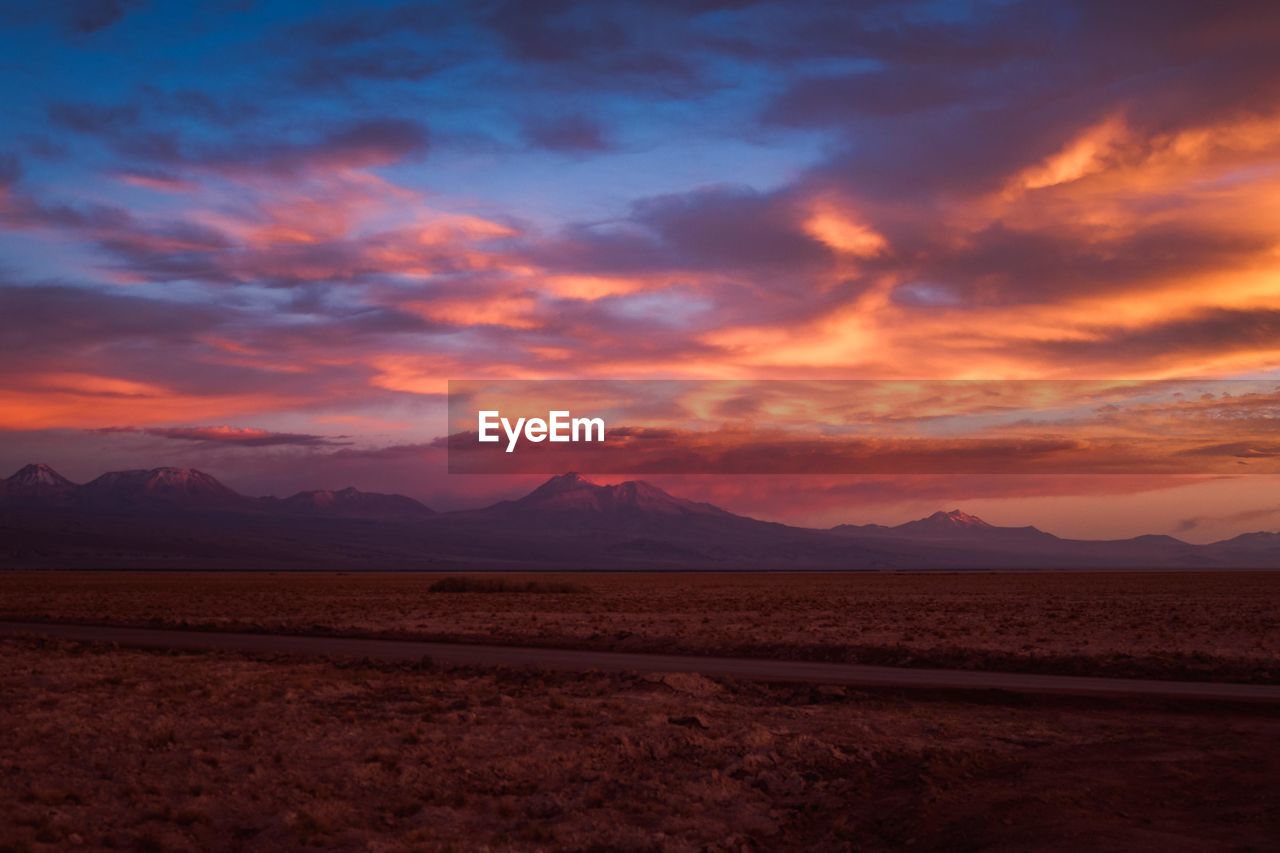 Scenic view of desert against sky during sunset