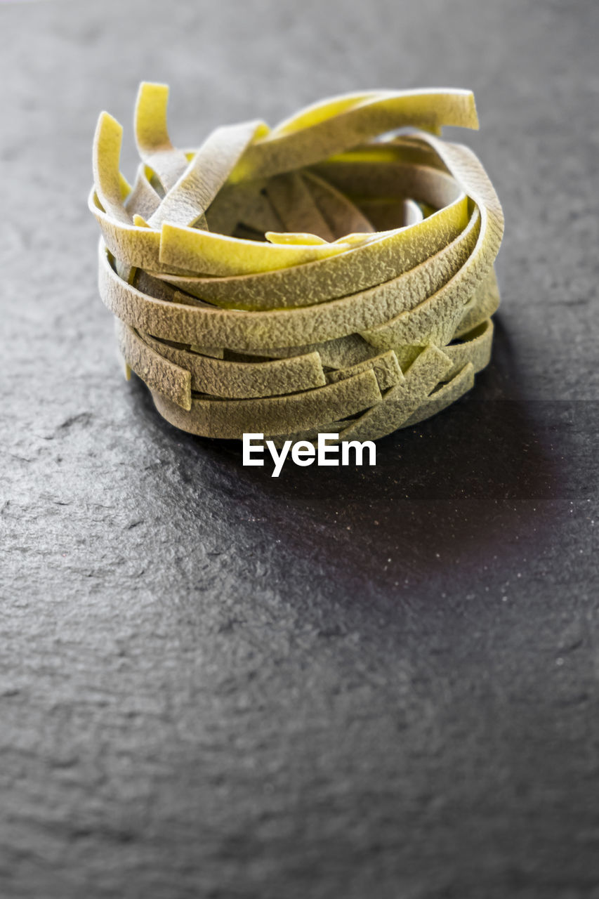 Close-up of raw tagliatelle on table