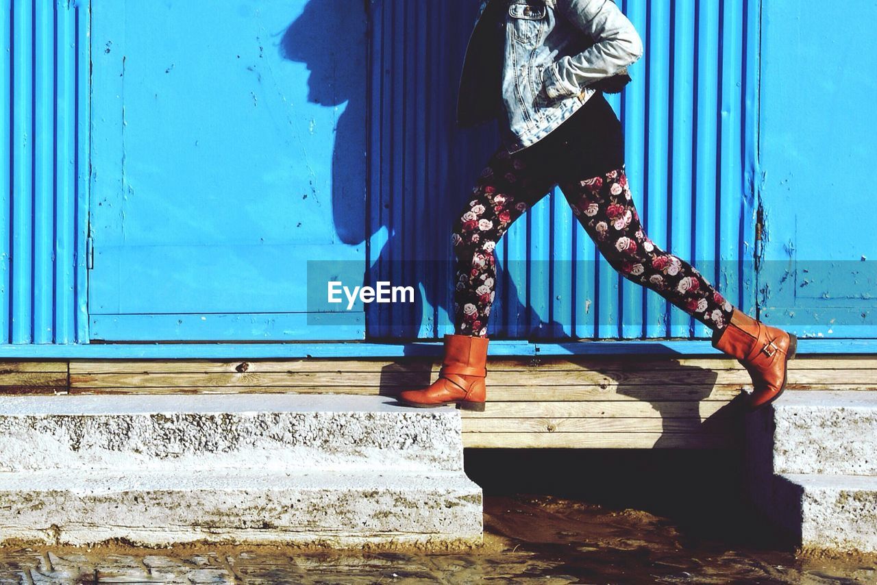 Low section of woman standing on steps