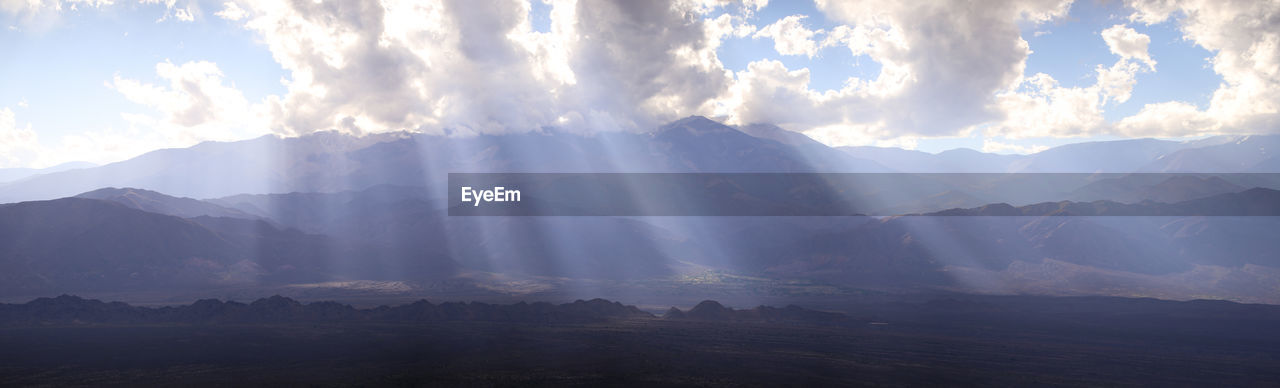 PANORAMIC VIEW OF MOUNTAIN RANGE AGAINST SKY