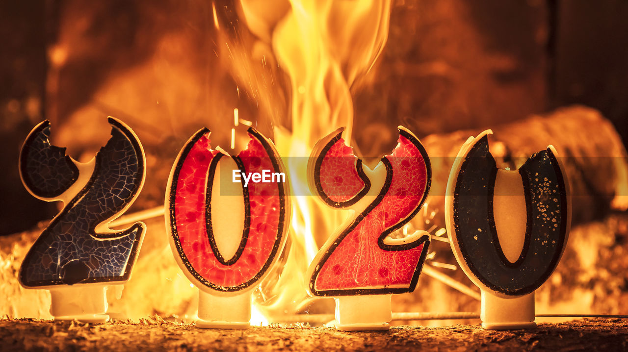 Close-up of 2020 numbers burning on table