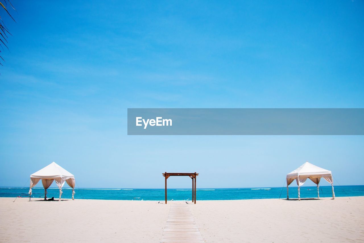 Scenic view of beach against blue sky